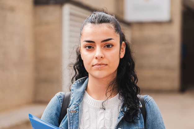 teen with tourette syndrome outside holding a folder