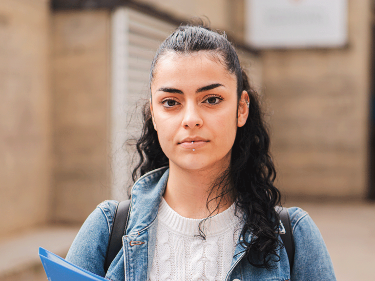 teen with tourette syndrome outside holding a folder